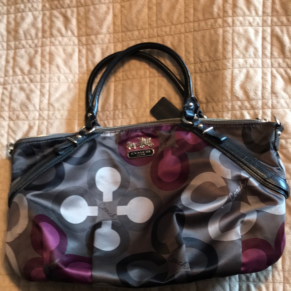 Multi color medium size coach handbag with c’s.